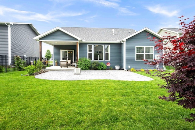back of property featuring a patio and a shingled roof