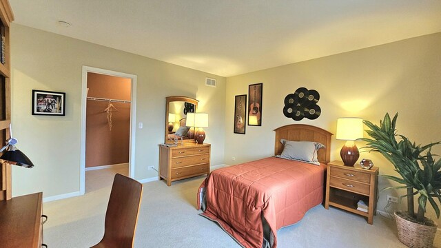 20161 Preston Ln, Lynwood, IL 60411 - bedroom featuring a walk in closet, light carpet, a closet, and baseboards