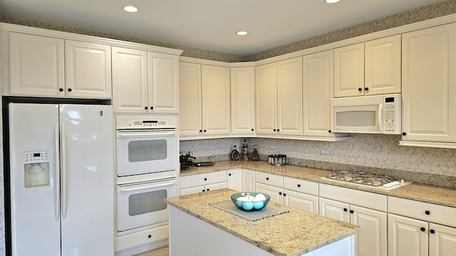 20161 Preston Ln, Lynwood, IL 60411 - kitchen featuring white appliances, a kitchen island, light stone countertops, recessed lighting, and white cabinets