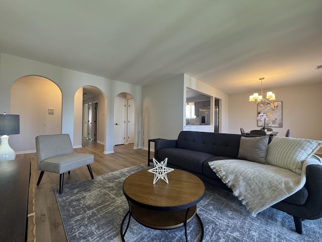 5024 W 122nd St Unit 2B, Alsip, IL 60803 - living area featuring arched walkways, a chandelier, and light wood finished floors