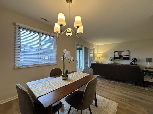 5024 W 122nd St Unit 2B, Alsip, IL 60803 - dining area with a chandelier, plenty of natural light, and wood finished floors