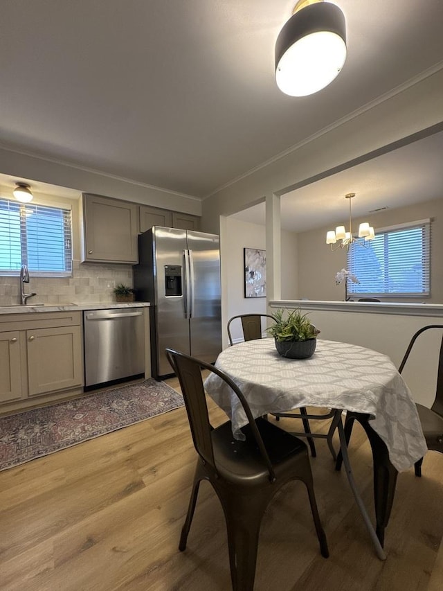 5024 W 122nd St Unit 2B, Alsip, IL 60803 - dining area featuring light wood-type flooring, a chandelier, and ornamental molding