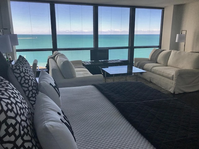 living room with a water view and a wall of windows