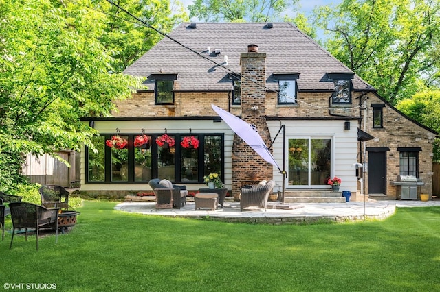 505 Jackson Ave, Glencoe, IL 60022 - back of house featuring a lawn, a patio, a chimney, and brick siding