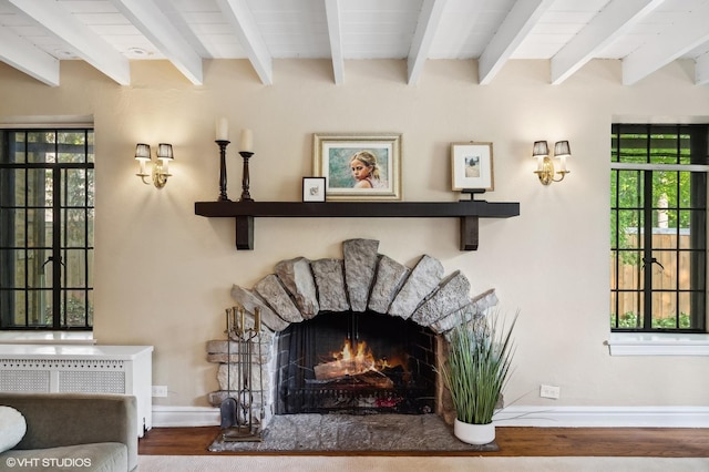505 Jackson Ave, Glencoe, IL 60022 - detailed view of wood finished floors, a lit fireplace, and baseboards