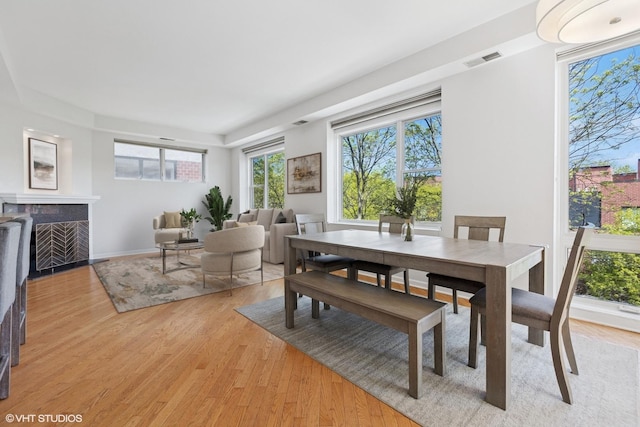 2307 W Wolfram St Unit 415, Chicago, IL 60618 - dining space featuring a fireplace and light wood-type flooring