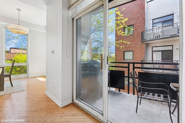2307 W Wolfram St Unit 415, Chicago, IL 60618 - entryway featuring baseboards, healthy amount of natural light, hardwood / wood-style flooring, and a towering ceiling