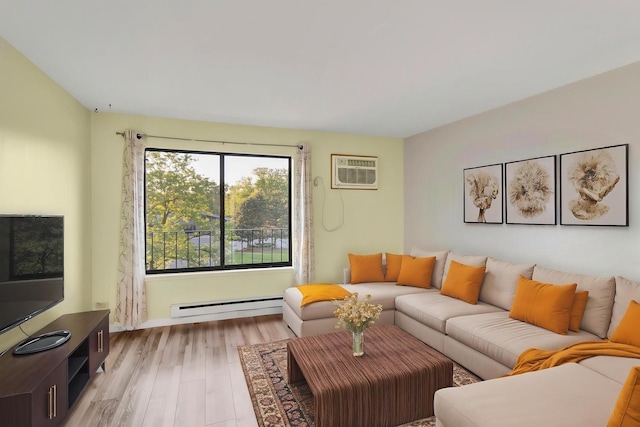living room featuring a baseboard heating unit, a wall mounted AC, light wood-style floors, and baseboards
