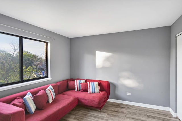 living area with wood finished floors and baseboards