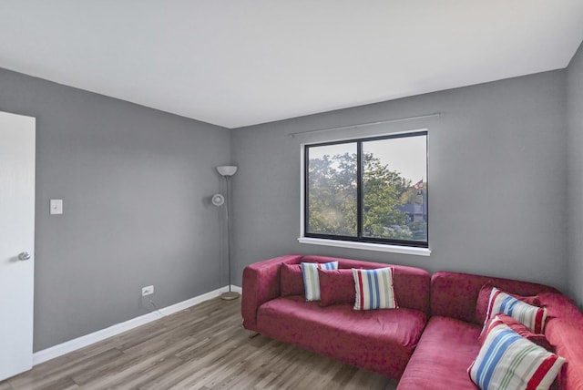living room featuring wood finished floors and baseboards
