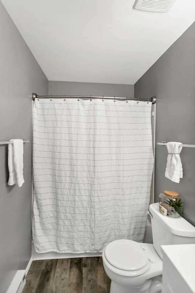 bathroom with wood finished floors and toilet