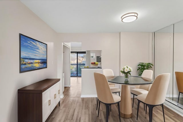 dining space featuring light wood-style flooring
