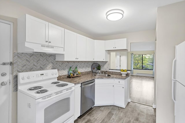 kitchen with white appliances, under cabinet range hood, a sink, white cabinets, and decorative backsplash