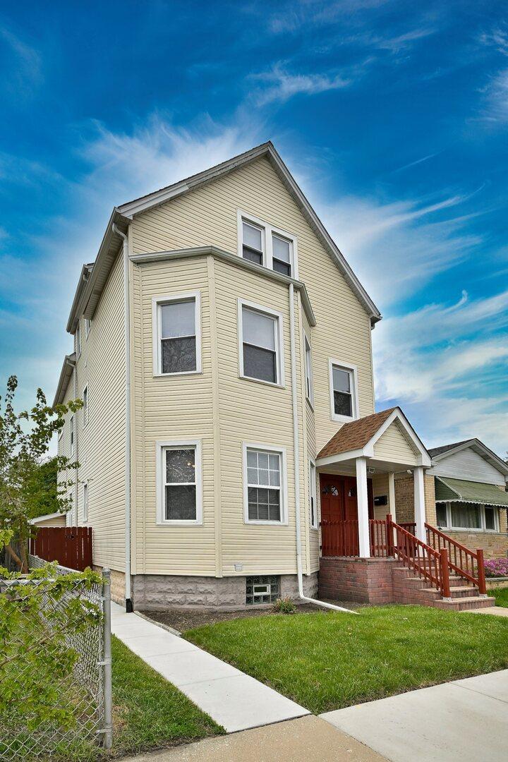 5104 N Austin Ave, Chicago, IL 60630 - view of front of home featuring covered porch and a front yard