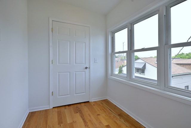 5104 N Austin Ave, Chicago, IL 60630 - empty room with baseboards and light wood finished floors