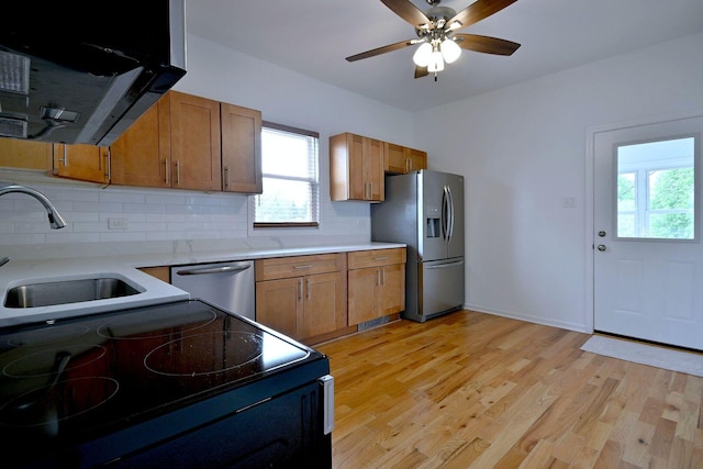 5104 N Austin Ave, Chicago, IL 60630 - kitchen with stainless steel appliances, plenty of natural light, backsplash, and range hood