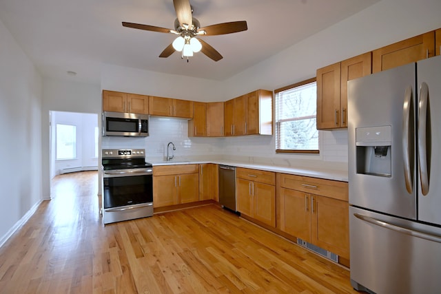 5104 N Austin Ave, Chicago, IL 60630 - kitchen with appliances with stainless steel finishes, light countertops, tasteful backsplash, and healthy amount of natural light