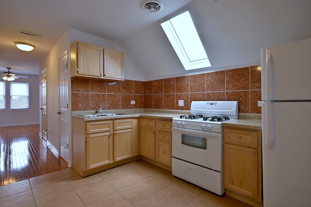 5104 N Austin Ave, Chicago, IL 60630 - kitchen with white appliances, a sink, light brown cabinets, a skylight, and light countertops