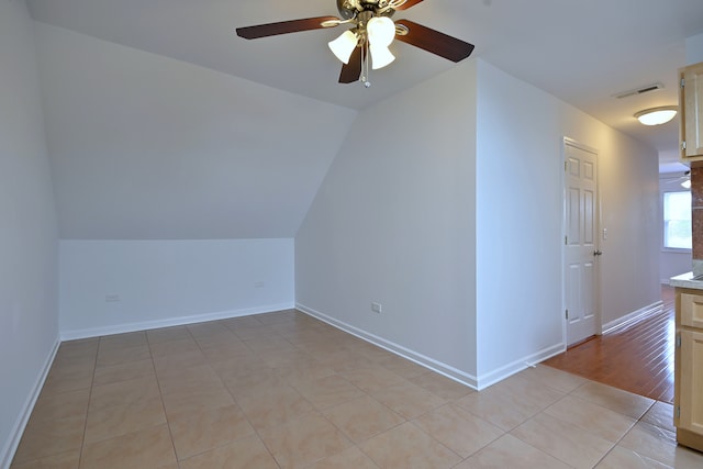 5104 N Austin Ave, Chicago, IL 60630 - bonus room with ceiling fan, lofted ceiling, light tile patterned flooring, and baseboards
