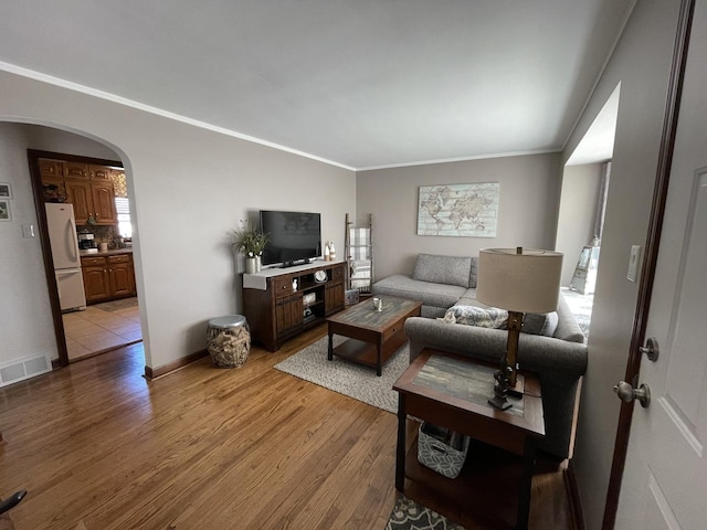 3254 W 115th St, Chicago, IL 60655 - living area featuring arched walkways, ornamental molding, light wood-style floors, and baseboards