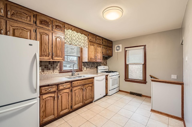 3254 W 115th St, Chicago, IL 60655 - kitchen with white appliances, a sink, light countertops, decorative backsplash, and baseboards