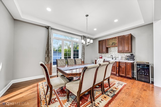 1327 Greenwood Ave, Deerfield, IL 60015 - dining space featuring beverage cooler, light wood-style flooring, a raised ceiling, baseboards, and recessed lighting