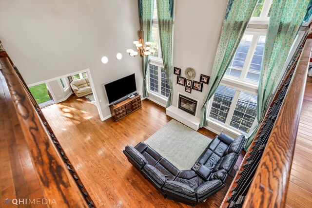 1327 Greenwood Ave, Deerfield, IL 60015 - living room with a high ceiling, wood finished floors, a chandelier, and baseboards