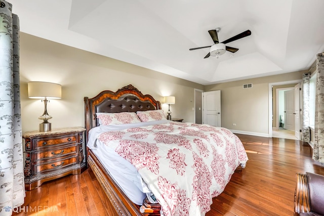 1327 Greenwood Ave, Deerfield, IL 60015 - bedroom with a tray ceiling, hardwood / wood-style flooring, baseboards, and a ceiling fan