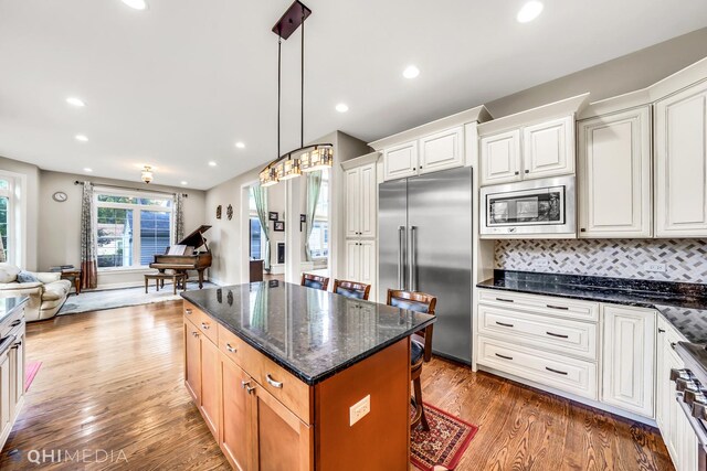 1327 Greenwood Ave, Deerfield, IL 60015 - kitchen with built in appliances, open floor plan, light wood-style flooring, white cabinetry, and recessed lighting