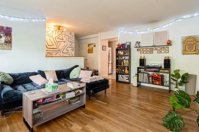 living room with wood finished floors and track lighting