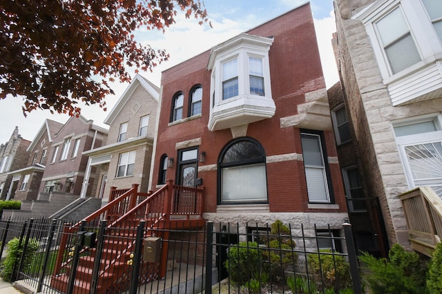 523 E 41st St, Chicago, IL 60653 - view of front facade featuring a fenced front yard, brick siding, and a gate