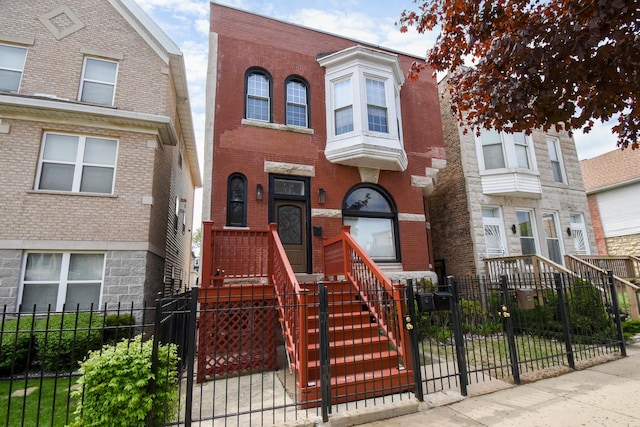 523 E 41st St, Chicago, IL 60653 - view of property featuring a fenced front yard, brick siding, and a gate