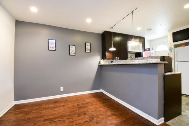 523 E 41st St, Chicago, IL 60653 - kitchen with white appliances, a peninsula, wood finished floors, hanging light fixtures, and baseboards