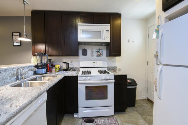 523 E 41st St, Chicago, IL 60653 - kitchen with white appliances, a sink, dark brown cabinets, and light stone countertops