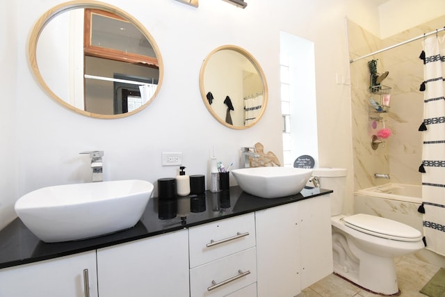 523 E 41st St, Chicago, IL 60653 - bathroom featuring double vanity, shower / bath combo with shower curtain, toilet, and tile patterned floors