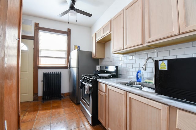 523 E 41st St, Chicago, IL 60653 - kitchen featuring radiator heating unit, stainless steel range with gas cooktop, and light brown cabinets