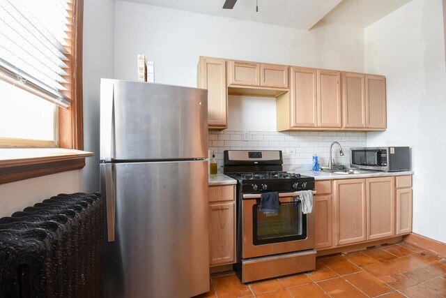 523 E 41st St, Chicago, IL 60653 - kitchen with appliances with stainless steel finishes, light brown cabinetry, backsplash, light countertops, and a ceiling fan