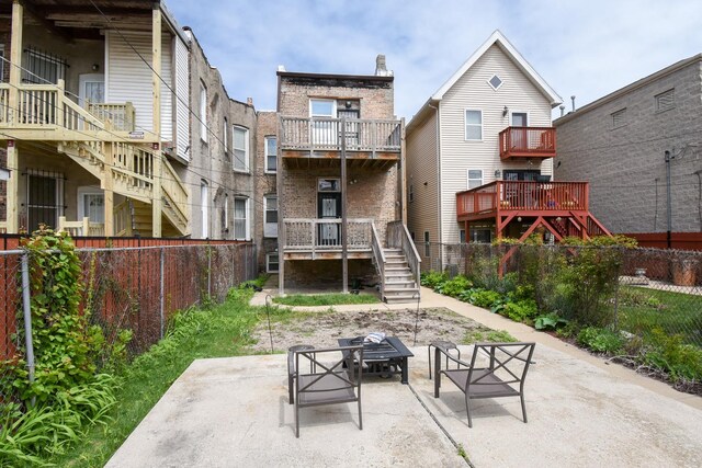 523 E 41st St, Chicago, IL 60653 - back of house with brick siding, stairs, a fenced backyard, and a patio