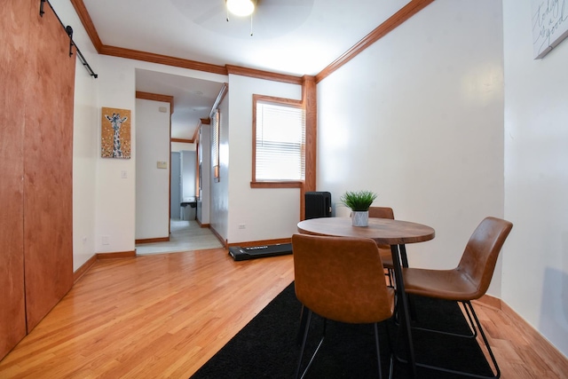 523 E 41st St, Chicago, IL 60653 - dining space featuring light wood-type flooring, a barn door, crown molding, baseboards, and ceiling fan