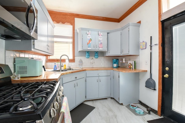 523 E 41st St, Chicago, IL 60653 - kitchen with appliances with stainless steel finishes, a sink, light marble finish flooring, tasteful backsplash, and crown molding