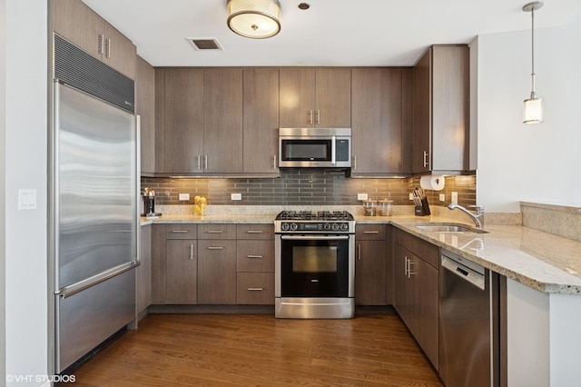 60 E Monroe St Unit 3308, Chicago, IL 60603 - kitchen featuring stainless steel appliances, a sink, dark wood-style flooring, and light stone countertops