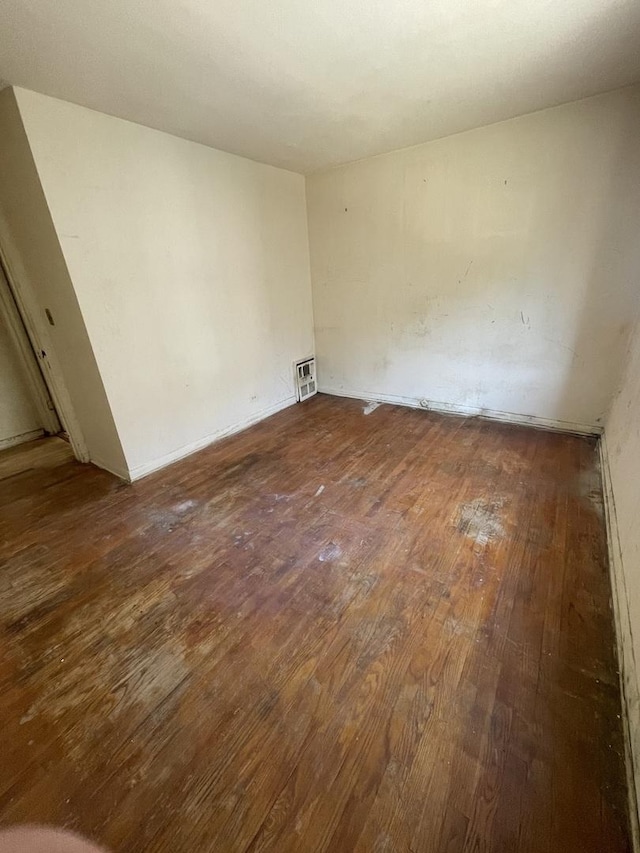 empty room with hardwood / wood-style floors