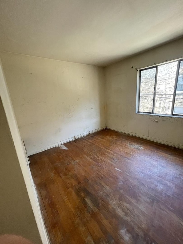 unfurnished room with wood finished floors