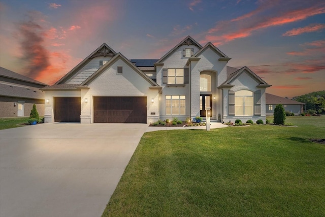 604 Cayman Way, Savoy, IL 61874 - french country home with solar panels, a yard, concrete driveway, and a garage
