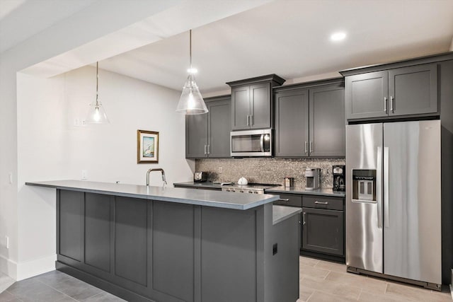 604 Cayman Way, Savoy, IL 61874 - kitchen featuring appliances with stainless steel finishes, tasteful backsplash, a peninsula, hanging light fixtures, and gray cabinetry