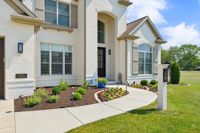 604 Cayman Way, Savoy, IL 61874 - view of exterior entry with a yard and brick siding
