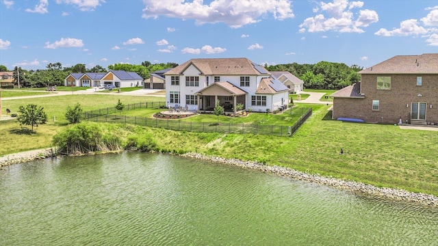 604 Cayman Way, Savoy, IL 61874 - back of property with a water view, a fenced backyard, and a patio area