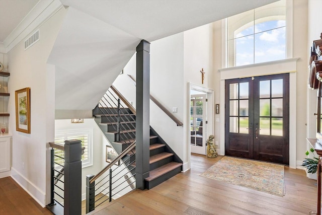 604 Cayman Way, Savoy, IL 61874 - foyer with french doors, wood finished floors, healthy amount of natural light, a towering ceiling, and stairs