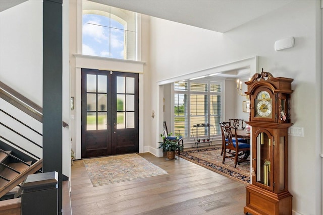 604 Cayman Way, Savoy, IL 61874 - entrance foyer featuring french doors, wood finished floors, stairway, and a towering ceiling