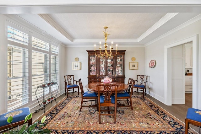 604 Cayman Way, Savoy, IL 61874 - dining space featuring a chandelier, wood finished floors, a raised ceiling, and crown molding